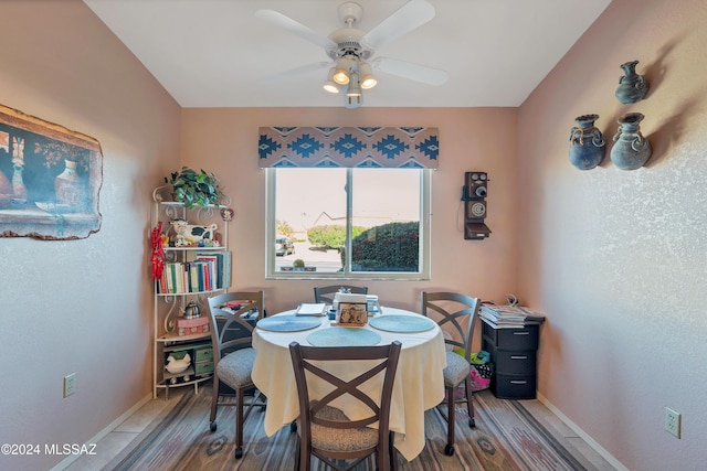 tiled dining room featuring ceiling fan