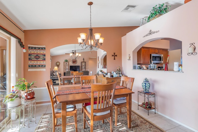 dining space featuring light tile patterned floors and a chandelier