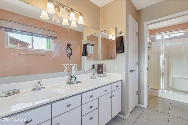 bathroom featuring tile patterned floors, a shower with door, and vanity