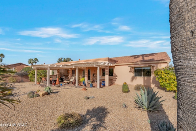 rear view of house with a pergola and a patio area