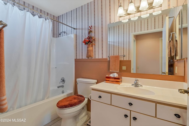 full bathroom with vanity, shower / bath combo, and toilet