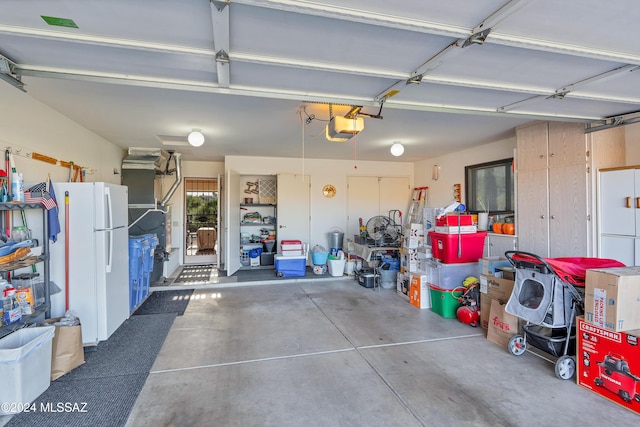 garage featuring a garage door opener and white refrigerator