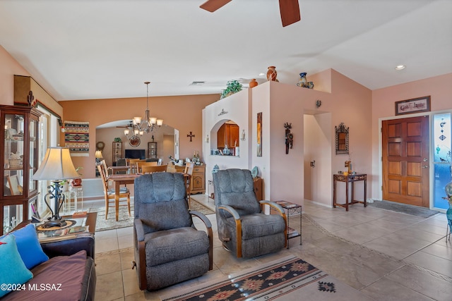 living room featuring light tile patterned floors, ceiling fan with notable chandelier, and lofted ceiling