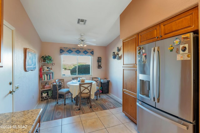 dining space with ceiling fan and light tile patterned floors