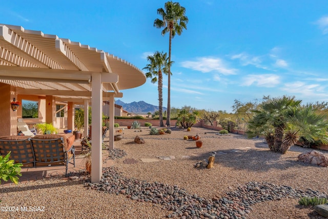 view of yard featuring a mountain view and a pergola