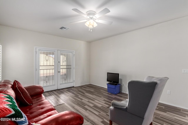 living area with ceiling fan, dark hardwood / wood-style flooring, and french doors