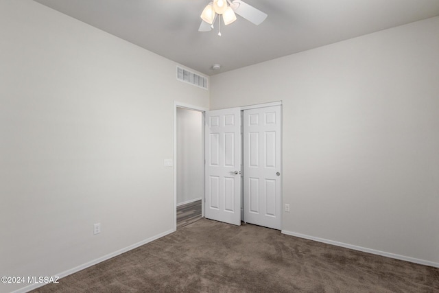 unfurnished bedroom with ceiling fan, a closet, and carpet floors