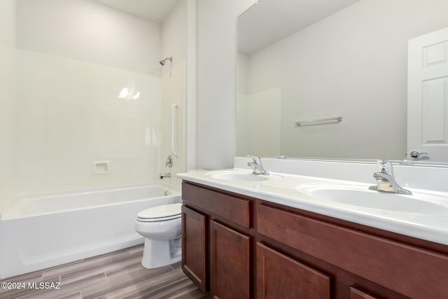 full bathroom featuring vanity, wood-type flooring, shower / bathtub combination, and toilet