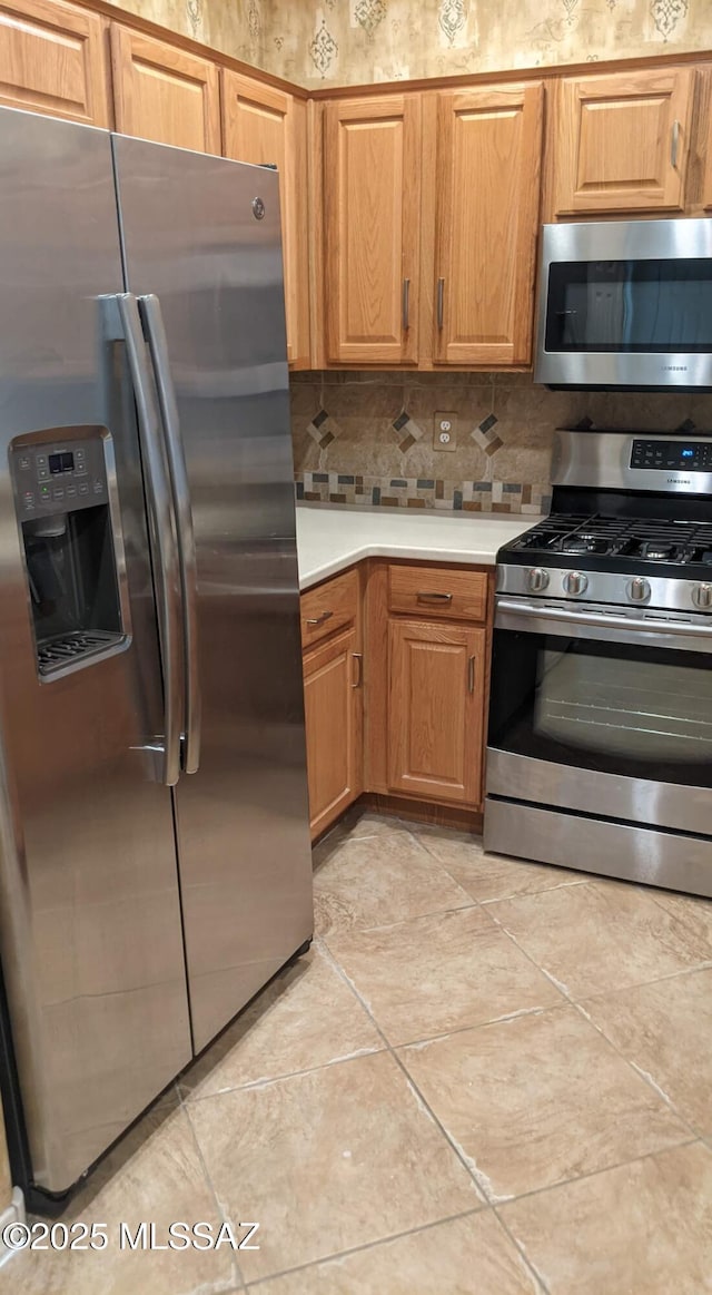 kitchen featuring decorative backsplash and appliances with stainless steel finishes