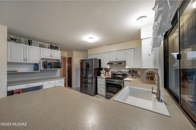 kitchen with sink, white cabinets, a textured ceiling, and appliances with stainless steel finishes