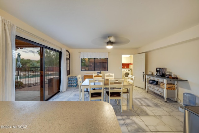 dining area with ceiling fan and washer / dryer