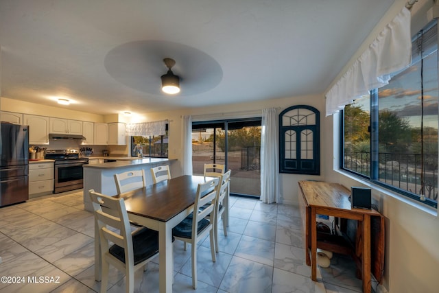 dining area with ceiling fan and sink