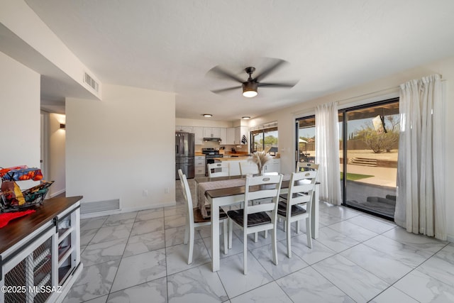dining space featuring visible vents, marble finish floor, baseboards, and a ceiling fan