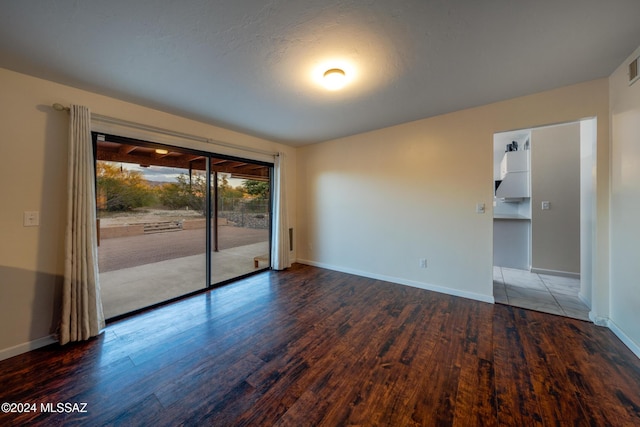 unfurnished room with wood-type flooring