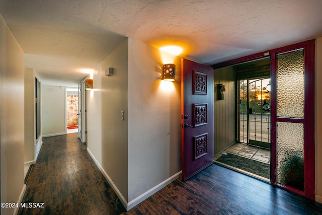entryway with hardwood / wood-style flooring, baseboards, and a textured ceiling