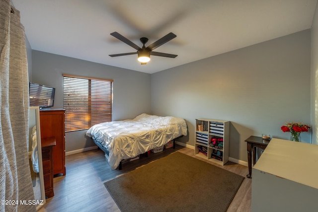 bedroom with wood-type flooring and ceiling fan