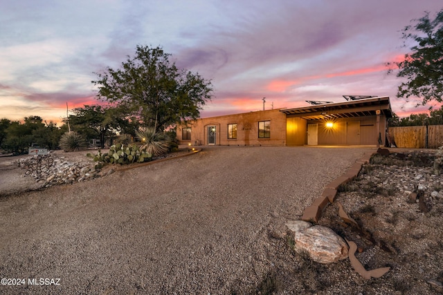 pueblo-style house featuring a carport