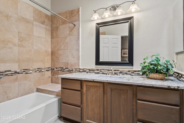 bathroom with tasteful backsplash and vanity