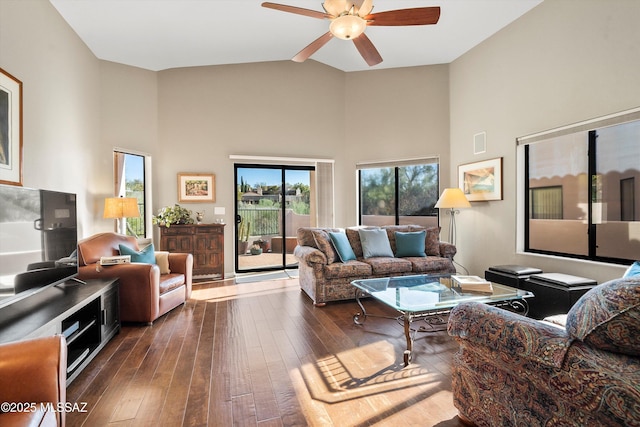 living room with high vaulted ceiling, ceiling fan, and dark hardwood / wood-style flooring