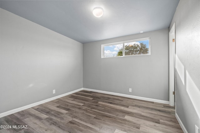 unfurnished room featuring dark hardwood / wood-style floors