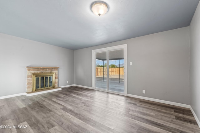 unfurnished living room featuring wood-type flooring and a fireplace