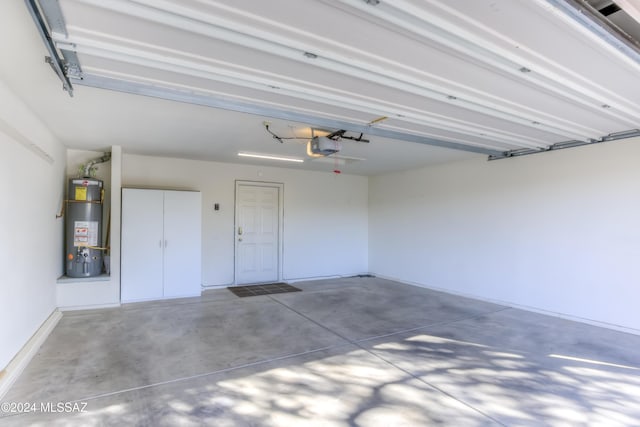 garage featuring water heater and a garage door opener