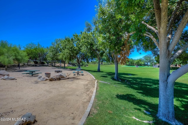 view of property's community featuring a lawn and volleyball court