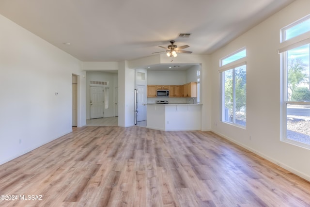 unfurnished living room with ceiling fan and light hardwood / wood-style floors