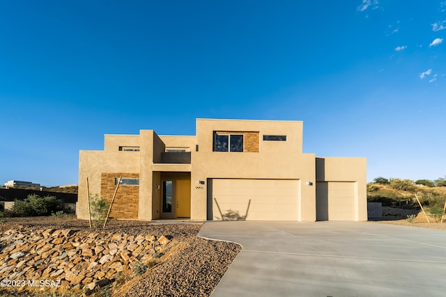 pueblo-style house with a garage