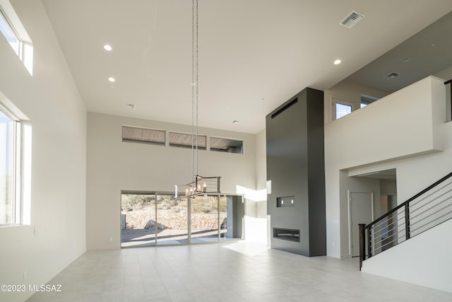 interior space featuring a towering ceiling and a notable chandelier