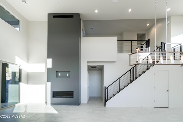 stairs featuring a high ceiling