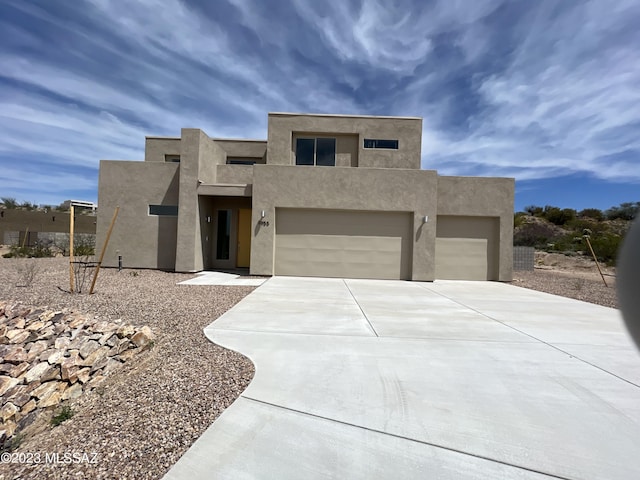 adobe home featuring a garage