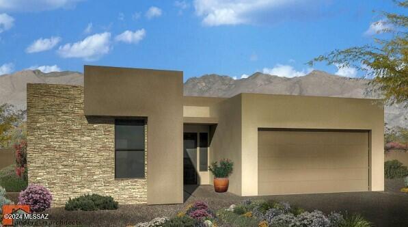 pueblo-style home featuring a mountain view and a garage