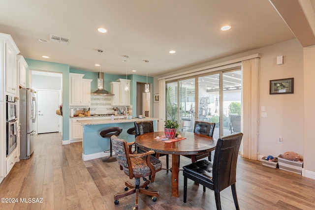 dining room with light hardwood / wood-style floors