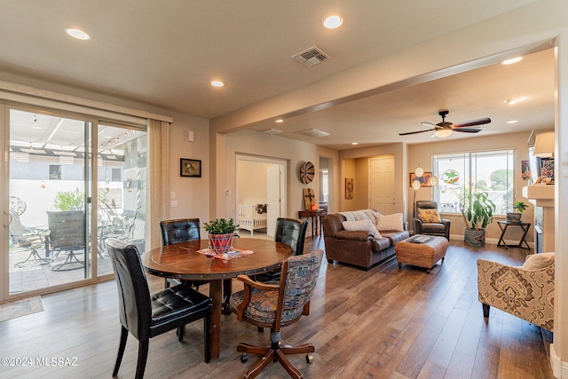 dining space with hardwood / wood-style flooring and ceiling fan