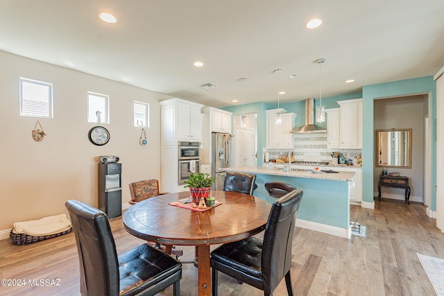 dining space with light hardwood / wood-style floors