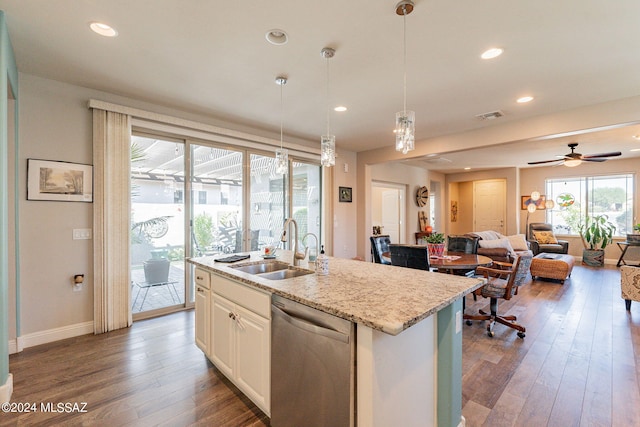 kitchen featuring pendant lighting, a center island with sink, stainless steel dishwasher, and sink