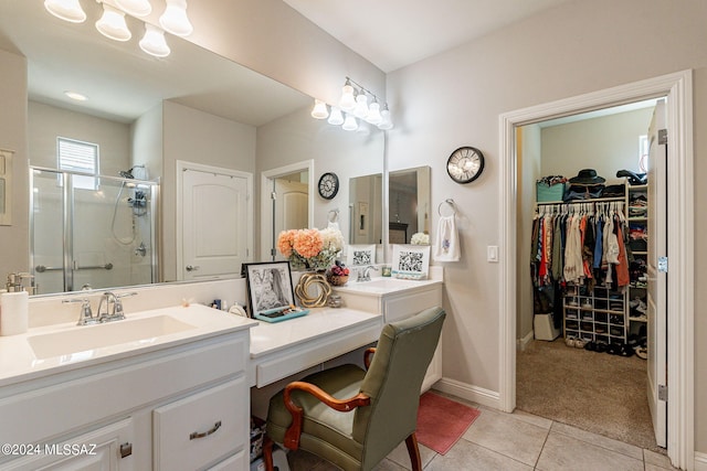 bathroom with tile patterned floors, vanity, and an enclosed shower