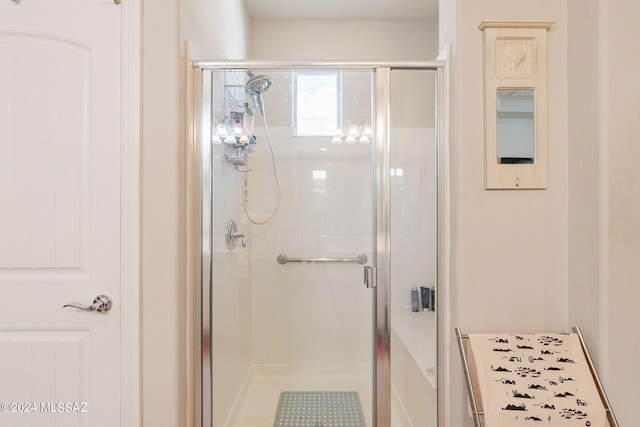 bathroom featuring a shower with door