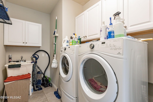 laundry area with cabinets, separate washer and dryer, and light tile patterned flooring