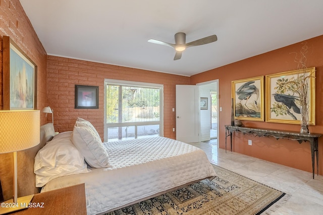 bedroom featuring ceiling fan, light tile patterned floors, and brick wall