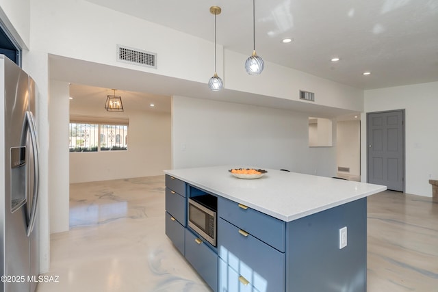 kitchen featuring blue cabinets, stainless steel appliances, a center island, and hanging light fixtures