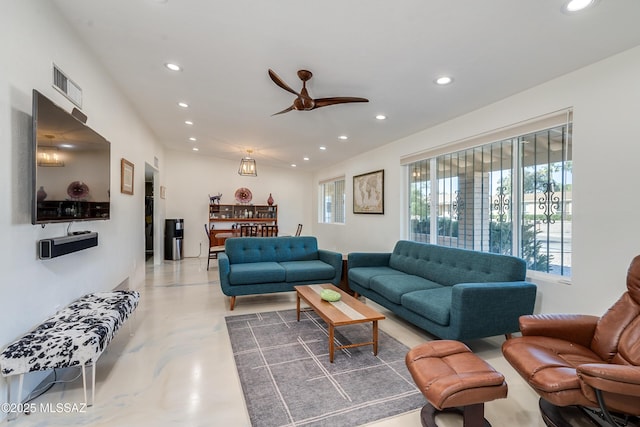 living room featuring concrete flooring and ceiling fan