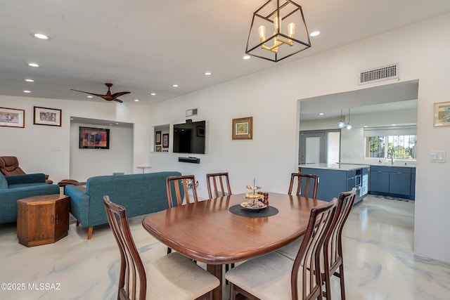 dining area with ceiling fan with notable chandelier