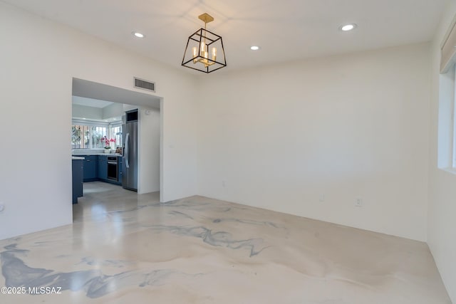 empty room featuring a notable chandelier