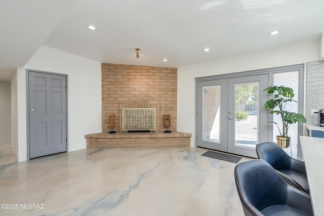 living room featuring french doors and a brick fireplace