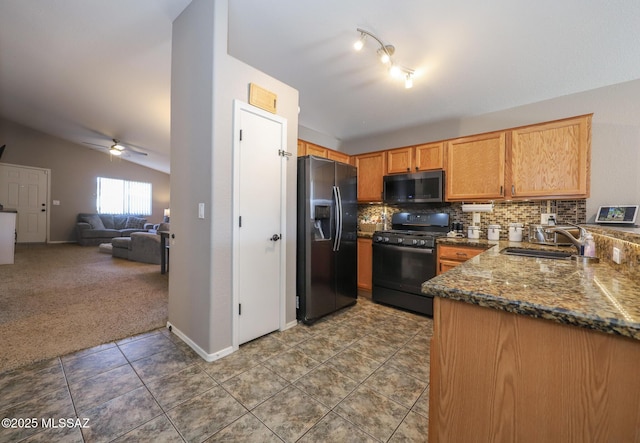 kitchen with tasteful backsplash, stainless steel appliances, vaulted ceiling, ceiling fan, and sink