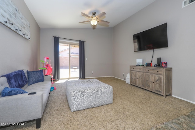 carpeted living room with ceiling fan and lofted ceiling