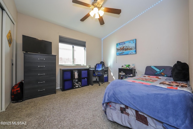 bedroom with carpet, a closet, ceiling fan, and lofted ceiling