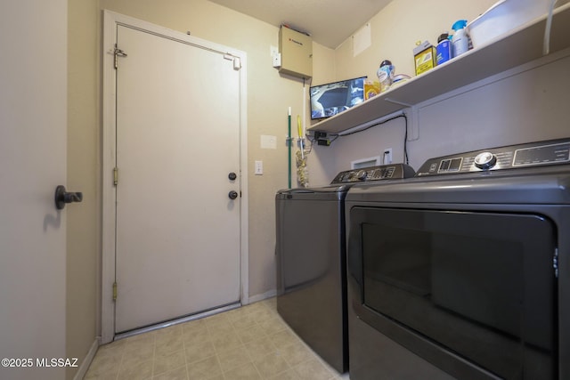 laundry area with washing machine and clothes dryer